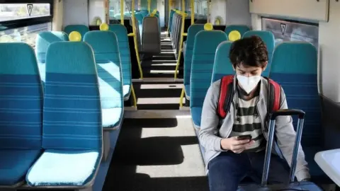 Reuters A man on a train with a mask on