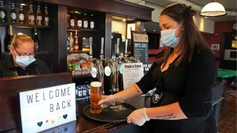 PA Media Members of staff wearing PPE at The Victoria in Whitley Bay, as pubs and bars have reopened following the easing of coronavirus lockdown restrictions across England.