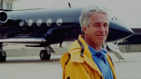 US Department of Justice/PA Jeffrey Epstein standing in front of his private plane