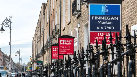 Getty Images  Several brokerage signs in a row outside apartments and offices. They are Georgian buildings in Dublin city centre