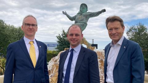 Three Boston and Skegness candidates stand near the Jolly Fishermen statue