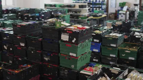 A close up picture of several full food crates in a warehouse