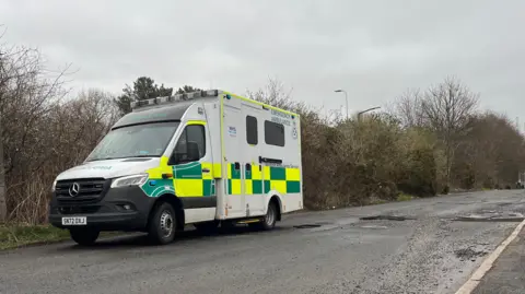 An ambulance avoiding potholes