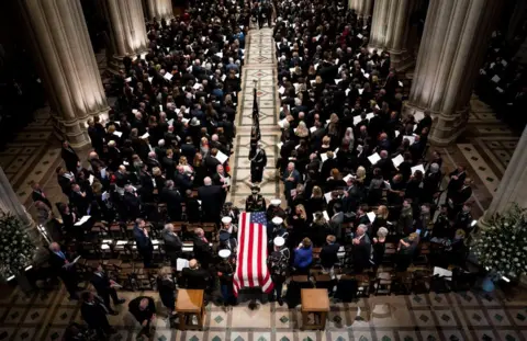 Getty Images A birds eye view of the congregation and coffin draped in a US flag holding the body of former president George HW Bush.