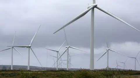 Wind turbines on top of a hill 