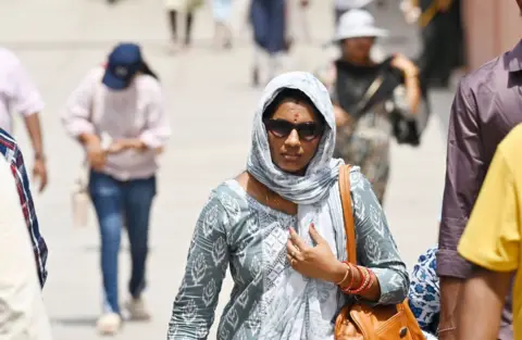 Getty Images Visitors brave the heat Wave during a hot summer afternoon at Kartavya Path Lawns, on June 4, 2024 in New Delhi, India.