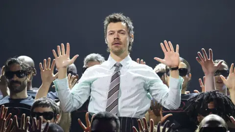 Getty Images Harry Styles with his hands up, surrounding by dancers during his performance at the Brit Awards at Manchester's Co-op Live Arena last month