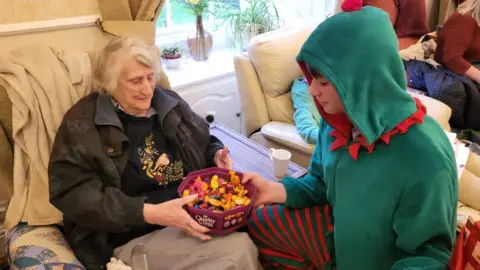 Amy Pulling Oscar delivering chocolates to residents