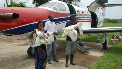 Jacklyn Reierson, MAF The twins and family after being flown back to their region