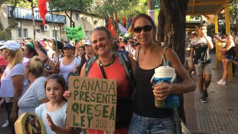 Courtesy of Carmen Dolores Piñeiro Carmen Dolores Piñeiro and her friend and daughter at a pro-choice march