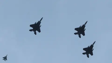 Raf fighter jets seen in the sky in a staged flypast tribute