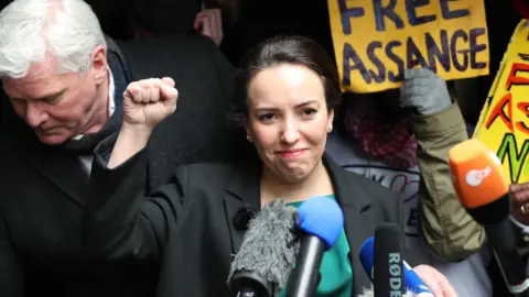 PA Media Wikileaks founder Julian Assange"s partner, Stella Moris, raises her fist as she speaks to the media outside the Old Bailey, London, following the ruling that he cannot be extradited to the United States. Assange, 49, was facing an 18-count indictment, alleging a plot to hack computers and a conspiracy to obtain and disclose national defence information.