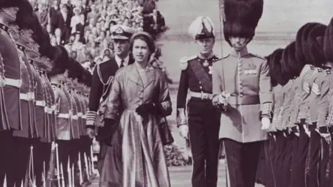 Getty Images The Queen inspects a line of Irish Guards at Stormont, Northern Ireland, in 1953