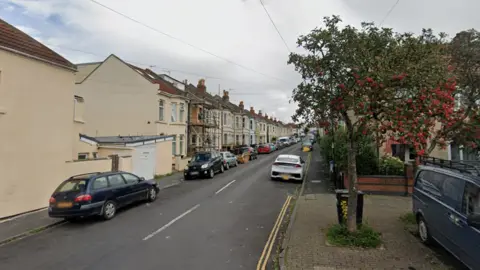 Google A Google street view of the entrance to Brittannia Street in Easton in Bristol. There are parked cars on each side of the street and the picture is taken on a bright, sunny day