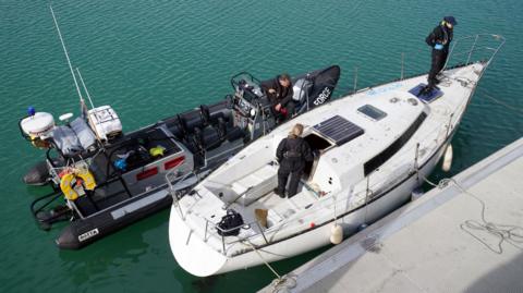 Border Force officers secure a yacht which was towed into Dover Harbour
