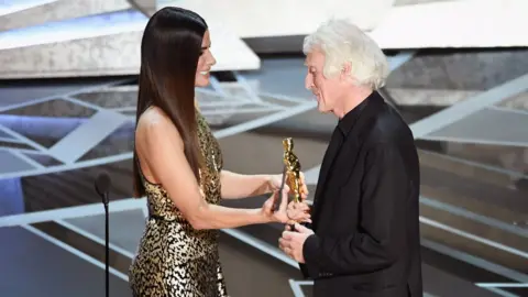 Getty Images Cinematographer Roger A. Deakins (R) accepts Best Cinematography for 'Blade Runner 2049' from actor Sandra Bullock onstage during the 90th Annual Academy Awards