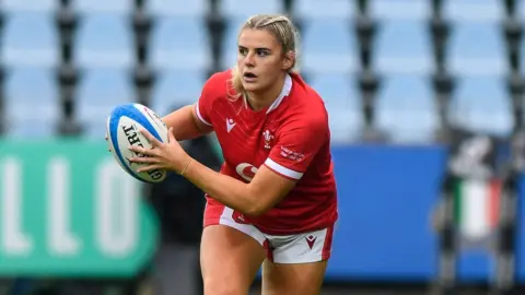 Carys Williams-Morris running with the ball during a game for Wales