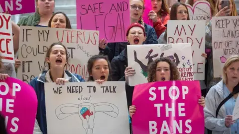 AFP Pro-choice activists hold signs at a rally to oppose abortion bans happening throughout the United States, at the State Capitol Building in Salt Lake City, Utah