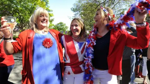 AFP Revellers cheer with Britain's Union flags during a street party to celebrate the Queen's Diamond Jubilee in Edinburgh on 3 June 2012