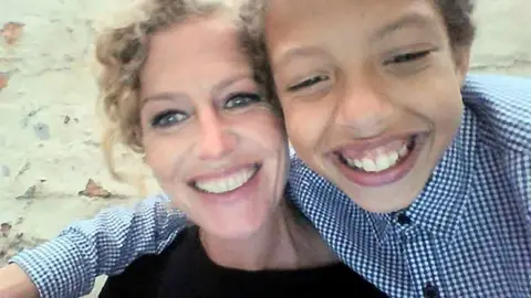 Pacemaker The picture shows a younger Noah Donohoe with his arm round his mother. Both are smiling 