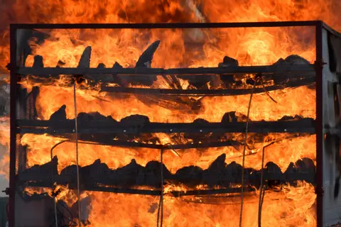 Biju Boro / AFP Seized rhino horns are burned in an anti-poaching drive in India.