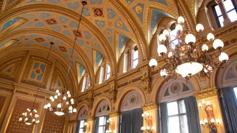 Mike Kemp/Getty Images The ornate curved gold ceiling of the FCDO's Lorcarno Suite, with chandeliers hanging from the roof