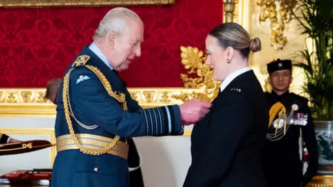 Police Constable Rhona Adams is decorated with the King's Commendation for Bravery by King Charles III, during an investiture ceremony at St James's Palace, London.
