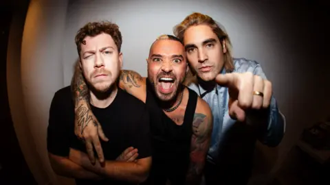 Plaster Communications Busted facing the camera in a promotion picture