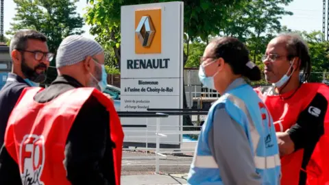 Getty Images Employees of French carmaker Renault gather near one of its Paris sites to protest