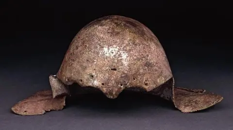 Trustees of the British Museum Britain's only surviving gladiator helmet - a domed bronze helmet with panels that would also protect the side of the head.