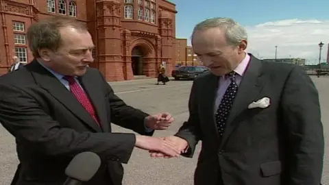 Ron Davies pays £1 for the lease of the land in which the Senedd now stands