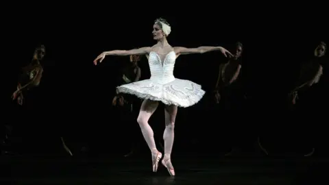 Getty Images A dancer performing in Swan Lake at the Royal Opera House