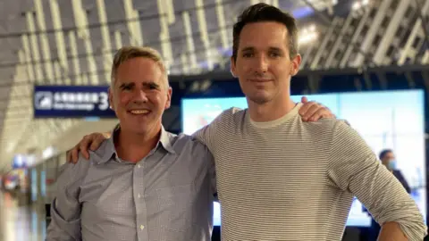 ABC Mike Smith and Bill Birtles at Shanghai airport on Monday