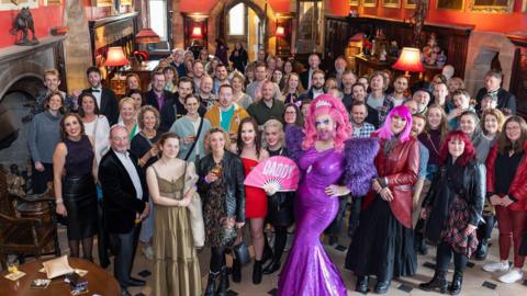 Drag queens and visitors in the castle's hall