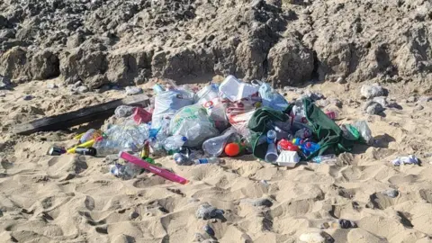 Julia James A range of litter and bags full of litter left on the beach at Cromer.