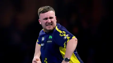 World championship runner up Luke Littler in a blue and yellow top