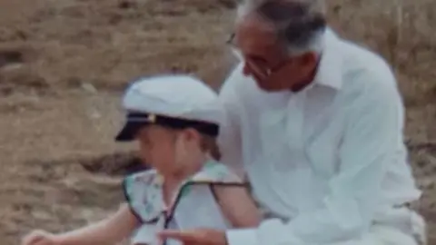 Katie Robinson Katie pictured on a beach alongside her grandfather 