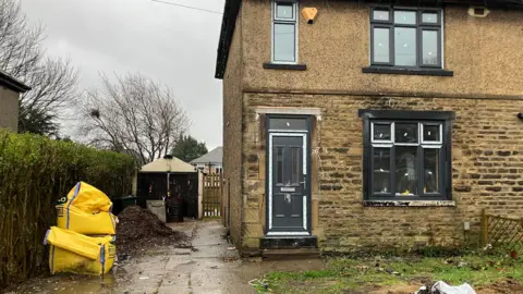 Steve Jones/BBC A semi-detached home with new glazing and a new front door in a matching grey colour.