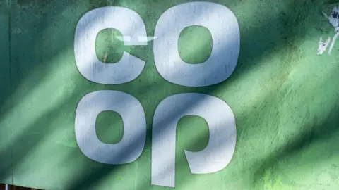 A faded sign showing the Co-op logo