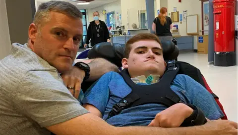 Leigh Day Cameron Mitchell (right) with his father Kevin (left)