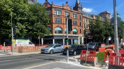 Nottingham City Council Orange barriers on top of new block paving at a pedestrian crossing