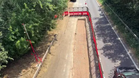 Oxfordshire County Council A lane closure on the A40. There is a big trench which has been dug in the closed lane.