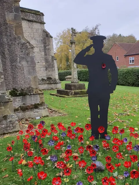 One of the silhouettes depicts a saluting Navy officer