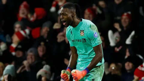 Wrexham goalkeeper Arthur Okonkwo celebrates