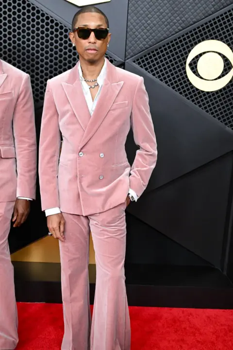 Getty Images Pharrell Williams in a pink suit