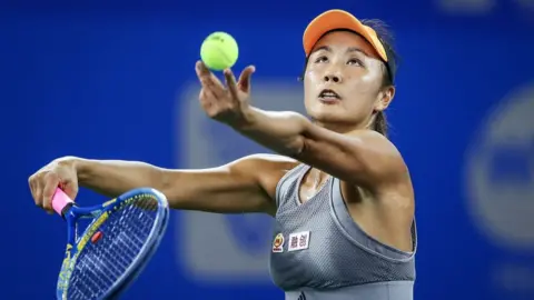 Getty Images Shuai Peng of China severs during the match in 2019