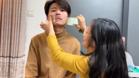 Social media Ms Dong taping her husband's mouth up in a video