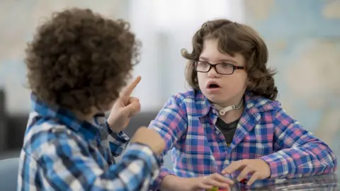 Getty Images Two deaf children talking in sign language
