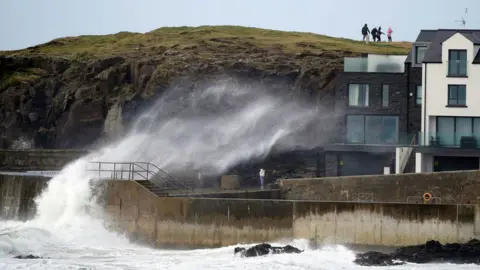 Niall Carson/PA Wire Big waves hit the sea wall at Portstewart in County Londonderry