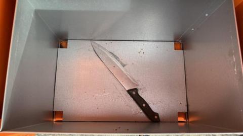A knife in a surrender bin